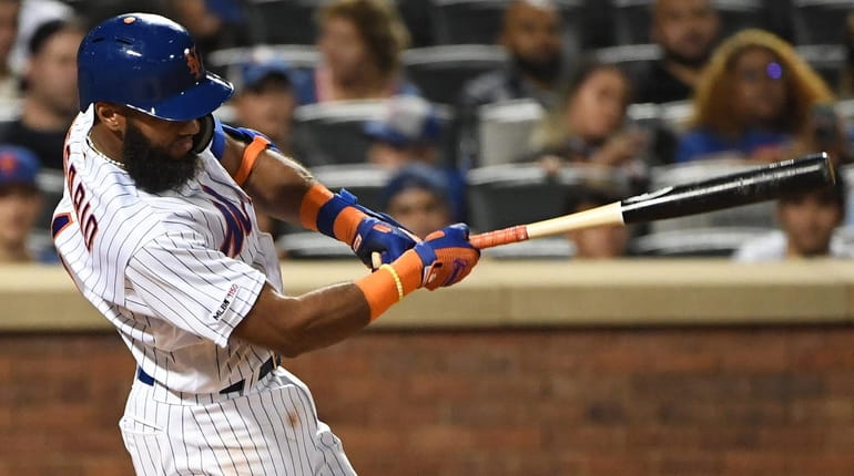 Mets shortstop Amed Rosario hits an RBI single against the...