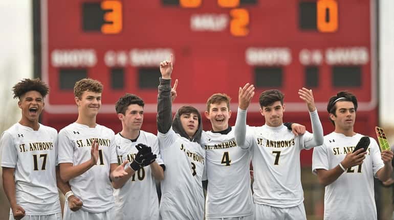 St. Anthony's boys soccer teammates salute their friends and family...