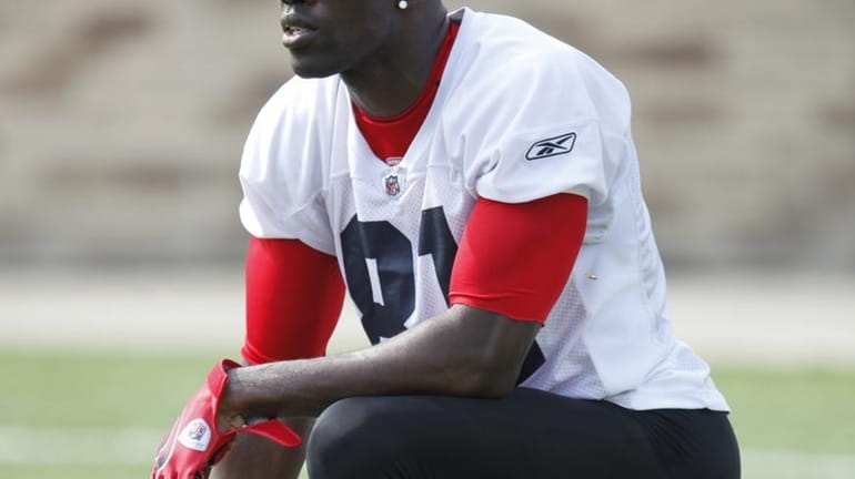 Terrell Owens pauses during NFL football training camp in Pittsford,...