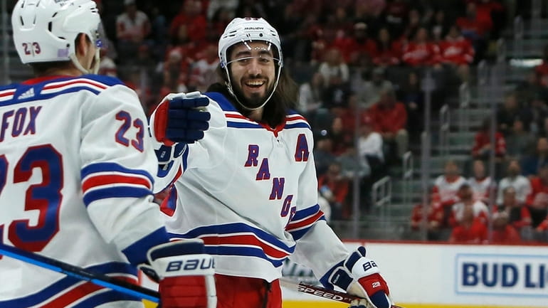 Rangers center Mika Zibanejad, right, celebrates after scoring against the...