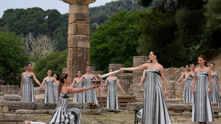 Performers take part in the official ceremony of the flame...