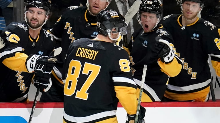 Pittsburgh Penguins' Sidney Crosby (87) returns to the bench after...