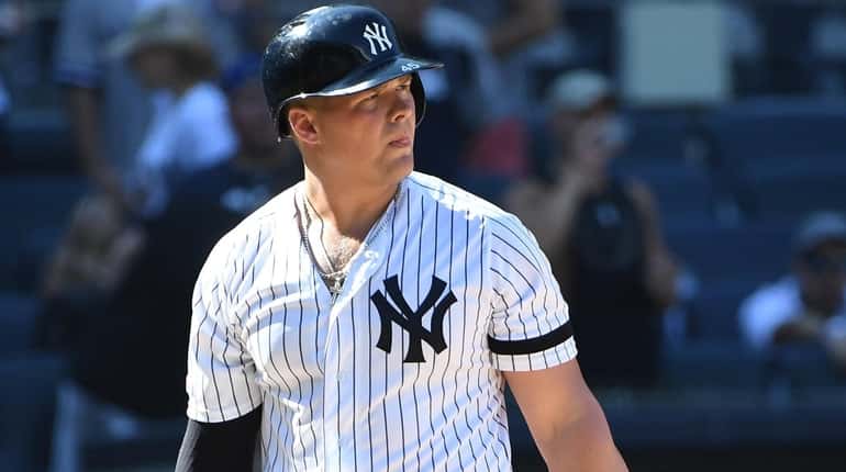 New York Yankees' Luke Voit returns to the dugout after...