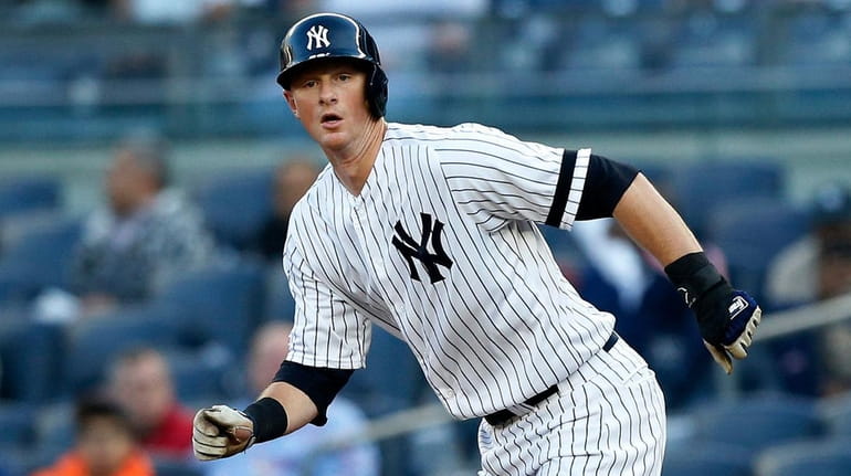 DJ LeMahieuof the Yankees breaks from first base during the first...