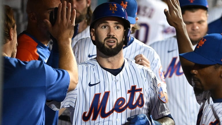 Mets catcher Tomas Nido is greeted in the dugout after...