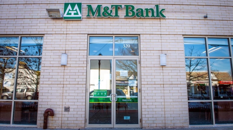 Signage outside a M&T Bank Corp. branch in White Plains,...
