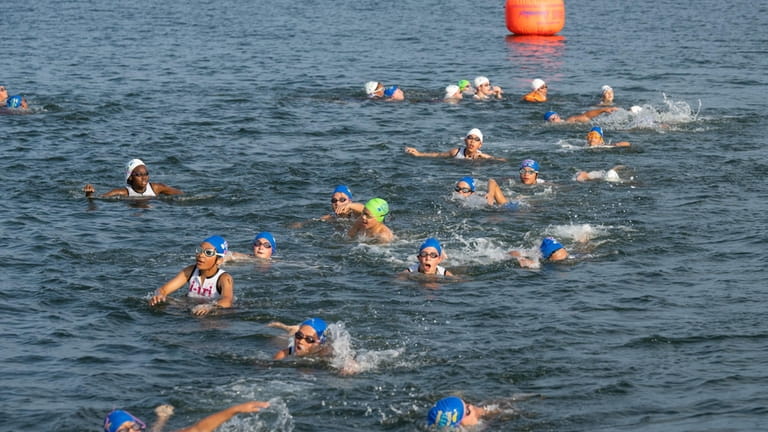 Participants from the nonprofit i-tri swim in July at Fosters Memorial...