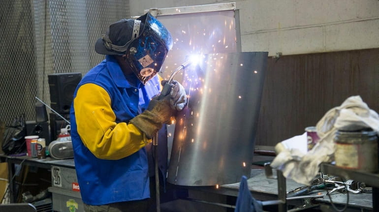 Umar Wyatt welds at Delta Sheet Metal Corp. on Thursday,...