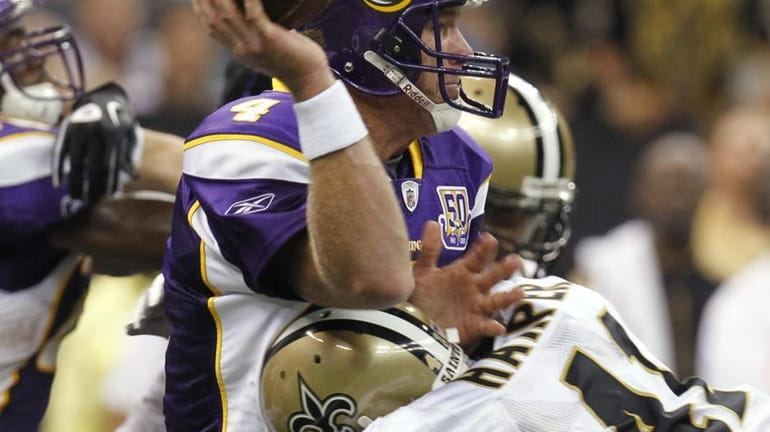 Minnesota Vikings quarterback Brett Favre is hit by New Orleans...