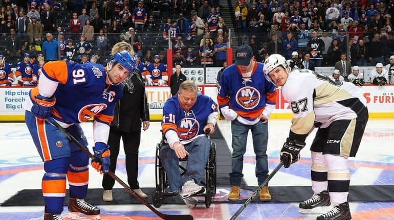 Ray Pfeifer, an FDNY 9/11 first responder, drops the puck...