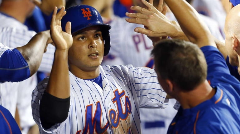 Ruben Tejada #11 of the New York Mets celebrates after...