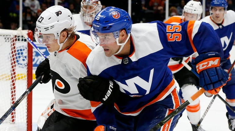 Johnny Boychuk of the Islanders defends against Oskar Lindblom of the Flyers during...