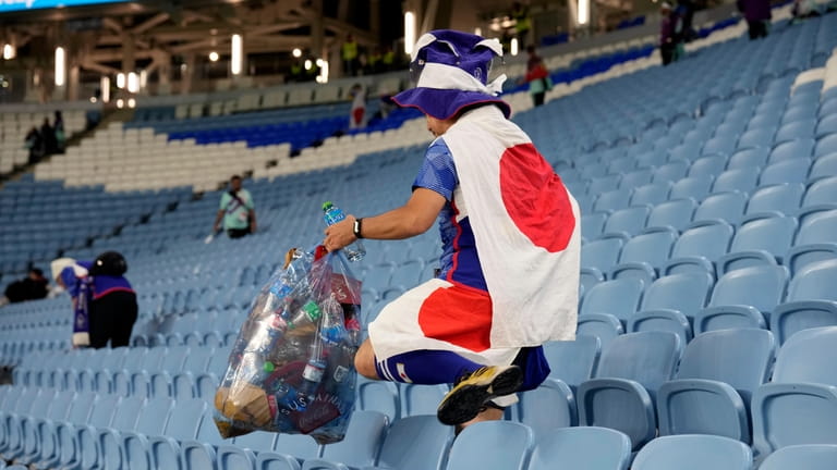 A fan of Japan collects garbages at the end of...