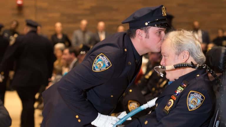 NYPD Officer Conor McDonald who was promoted to detective, kisses...