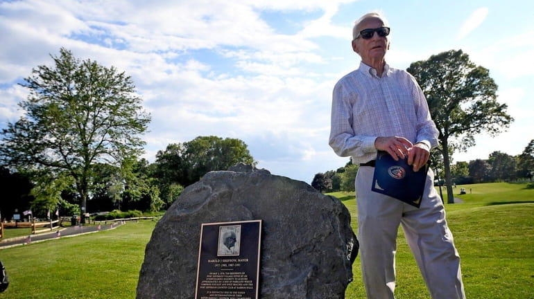 Former Port Jefferson Mayor Harold Sheprow walks past a plaque...