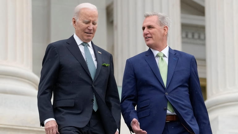 President Joe Biden talks with House Speaker Kevin McCarthy as...