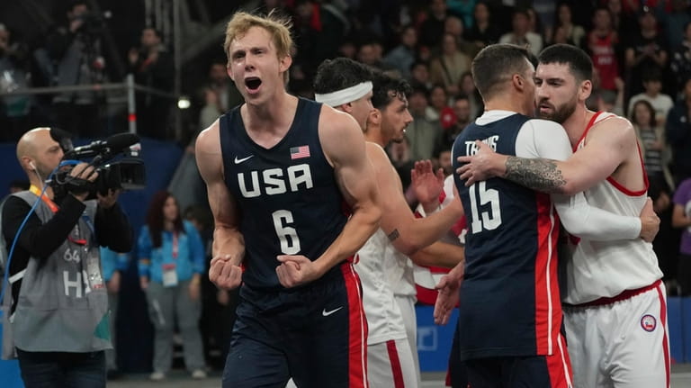 United States' Canyon Barry celebrates winning the men's 3x3 basketball...
