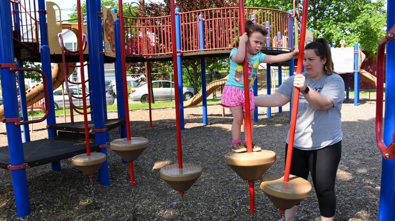 Sonya Tyburczy, 3, of Floral Park, plays with her mom...