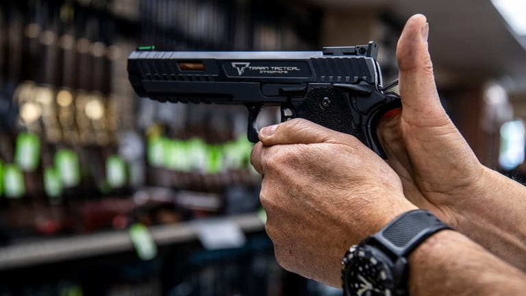 A customer checks out a handgun that is for sale...