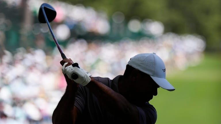 Tiger Woods hits his tee shot on the 14th hole...