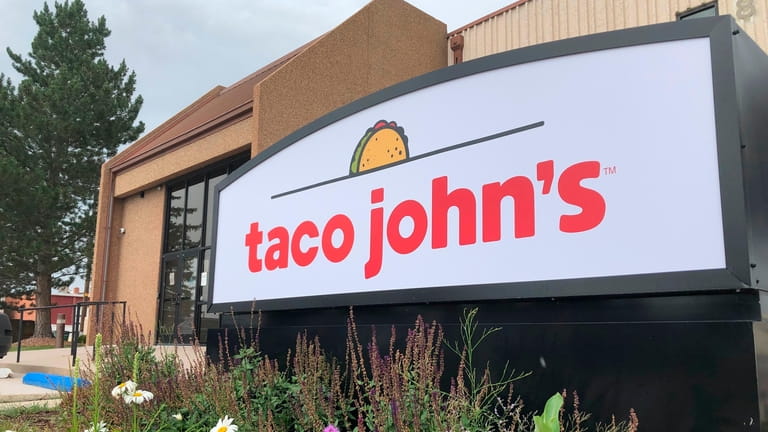 A sign stands outside the corporate headquarters of Cheyenne-based Taco...