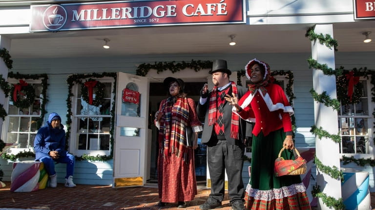 Milleridge Inn carolers sing Christmas songs at the Christmas village...