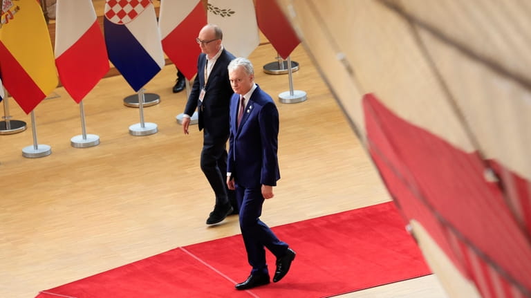 Lithuania's President Gitanas Nauseda, right, arrives for a EU Summit...