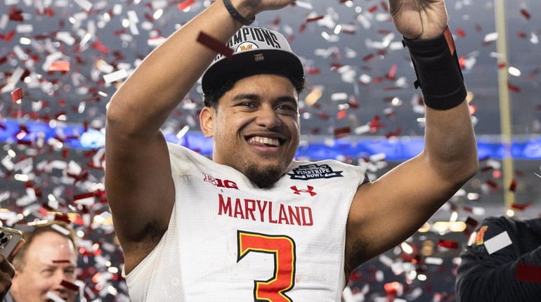 Taulia Tagovailoa of the Maryland Terrapins holds the MVP trophy...