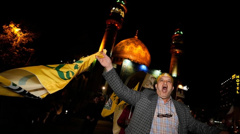 An Iranian demonstrator chants slogans while attending an anti-Israeli gathering...