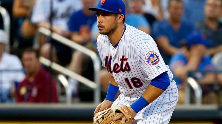 Travis d'Arnaud is positioned at third base during the second...