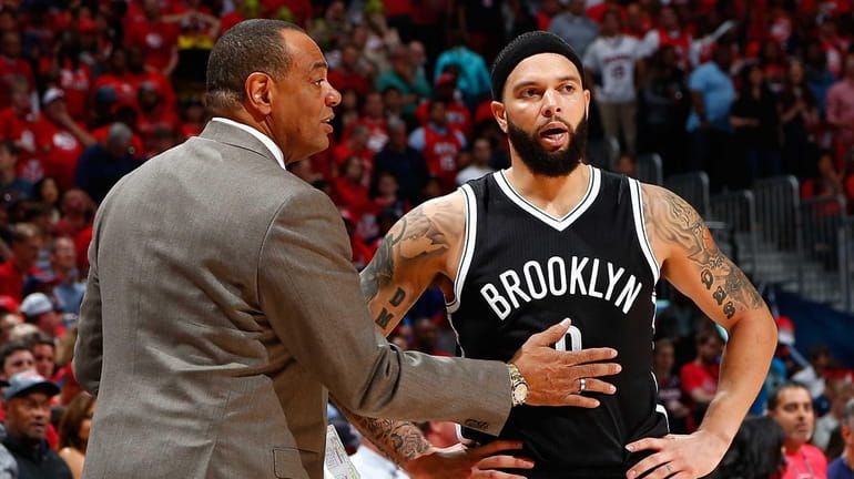 Lionel Hollins of the Brooklyn Nets converses with Deron Williams...