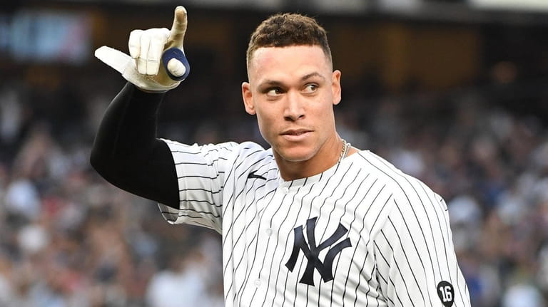 The Yankees' Aaron Judge acknowledges fans after his wild-card clinching...