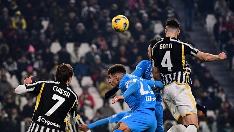 Juventus' Federico Gatti, right, scores during the Serie A soccer...