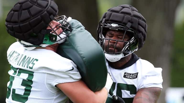 Jets left tackle George Fant does a blocking drill during...