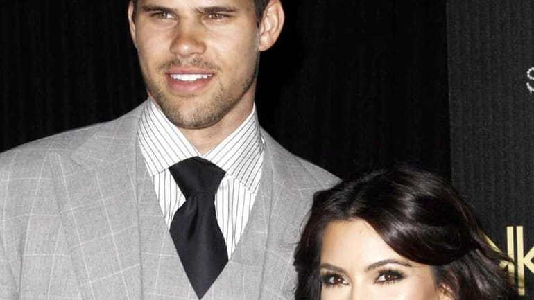 Reality TV personality Kim Kardashian, right, and her fiance, NBA...