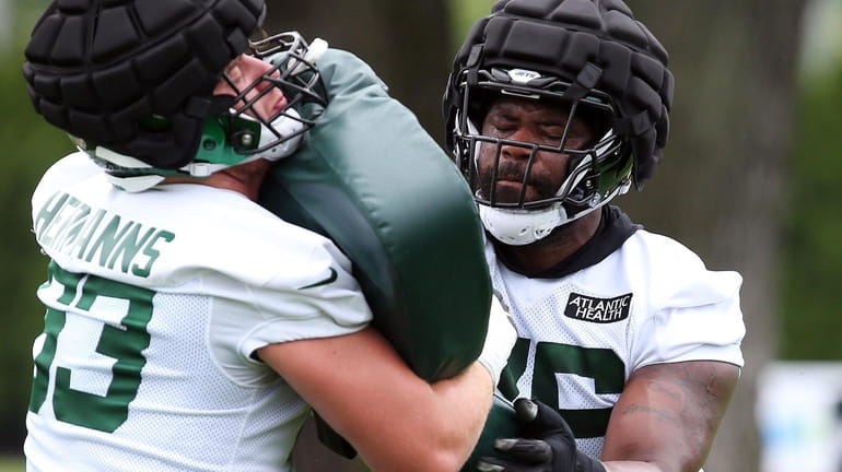 Jets tackle George Fant blocks during training camp at the Atlantic...
