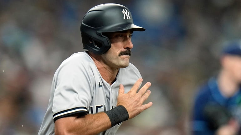 Yankees' Matt Carpenter runs to first base after grounding out...