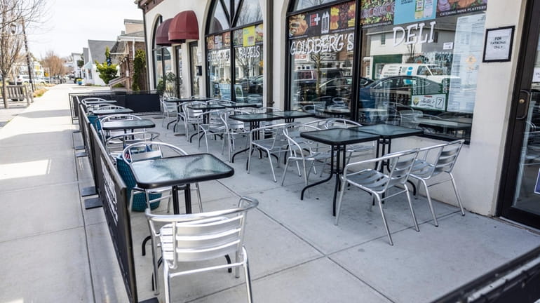 Tables are arranged for outdoor dining at Goldberg's deli in...