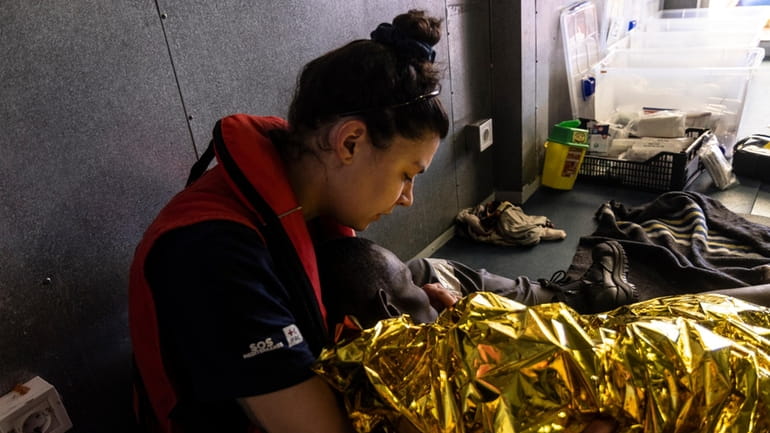 The rescue personnel of the SOS Mediteranee's humanitarian ship Ocean...