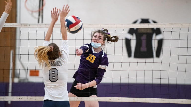Outside hitter, Morgan Reese, of Sayville spikes the ball during...