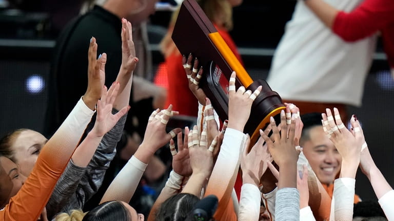 Texas players celebrate after winning the NCAA Division I women's...