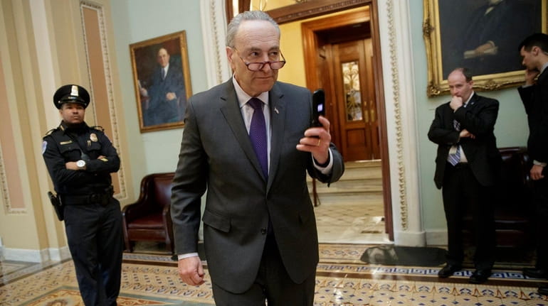 Senate Minority Leader Chuck Schumer (D-N.Y.), leaves the chamber after...
