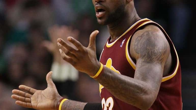 LeBron James #23 of the Cleveland Cavaliers reacts after a...