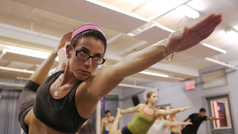 Lia Miele of Inwood particpates during a hot yoga class...