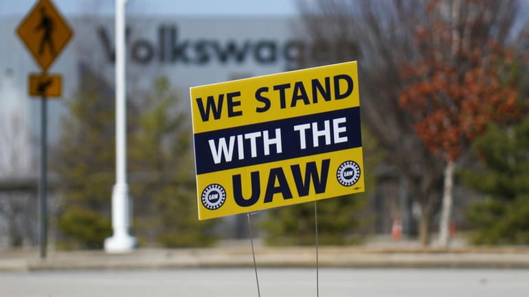 A "We stand with the UAW" sign appears outside of...