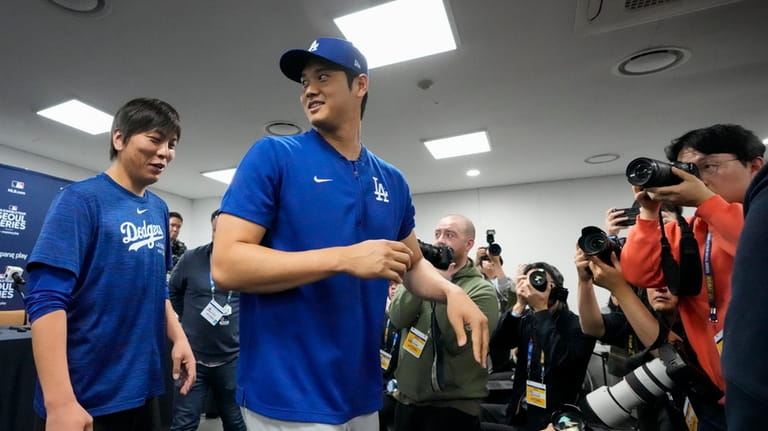 Los Angeles Dodgers' Shohei Ohtani, right, and his interpreter, Ippei...