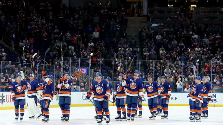 New York Islanders players acknowledge the fans after losing to...