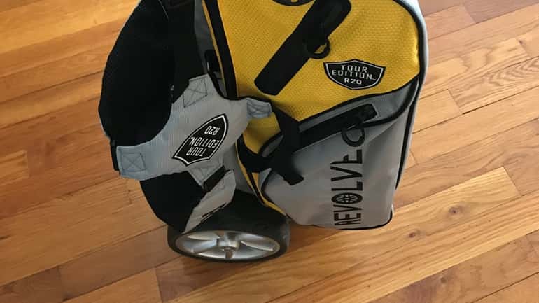 Photo of a golf bag with built-in wheels and handle...