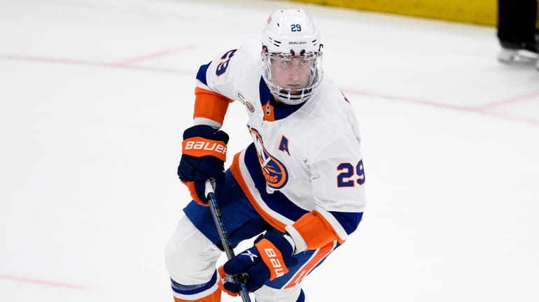 Islanders center Brock Nelson skates with the puck during overtime...