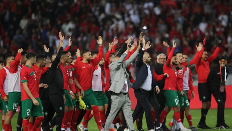 Players of Morocco celebrate their team's 2-1 victory over Brazil...